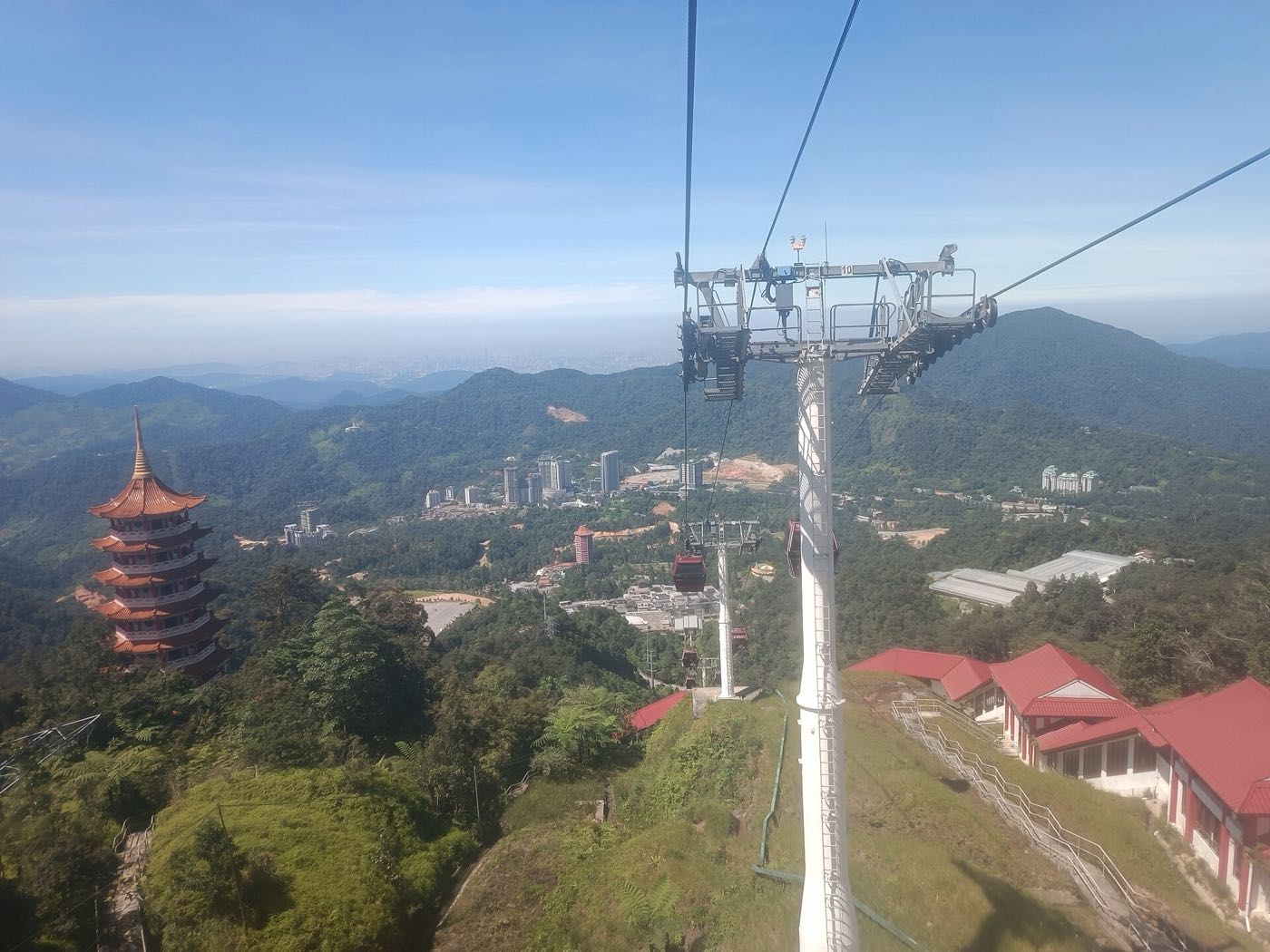 View from the Awana Skyway cable car over a temple pagoda and the forested hills of Genting