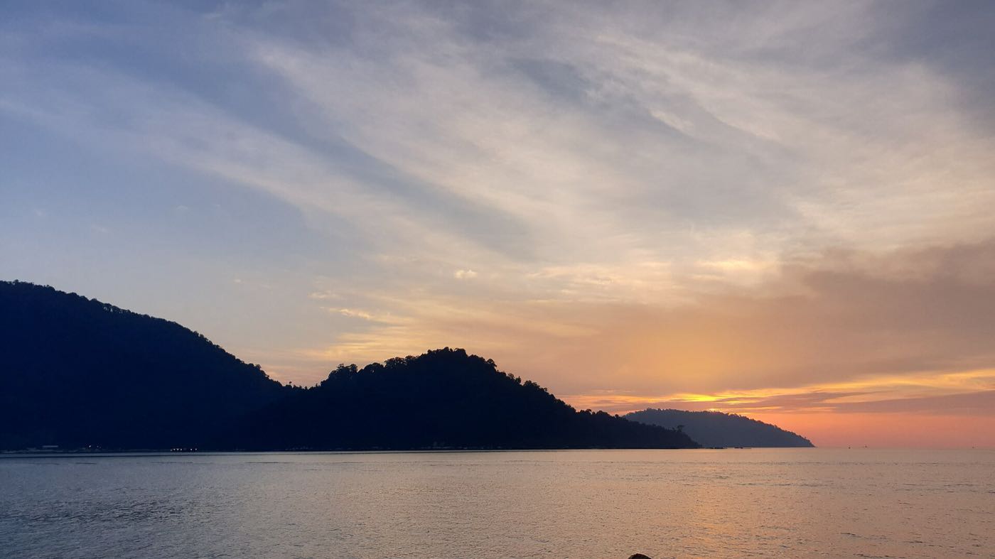 Sunset sky over the sea and hills of Pangkor Island